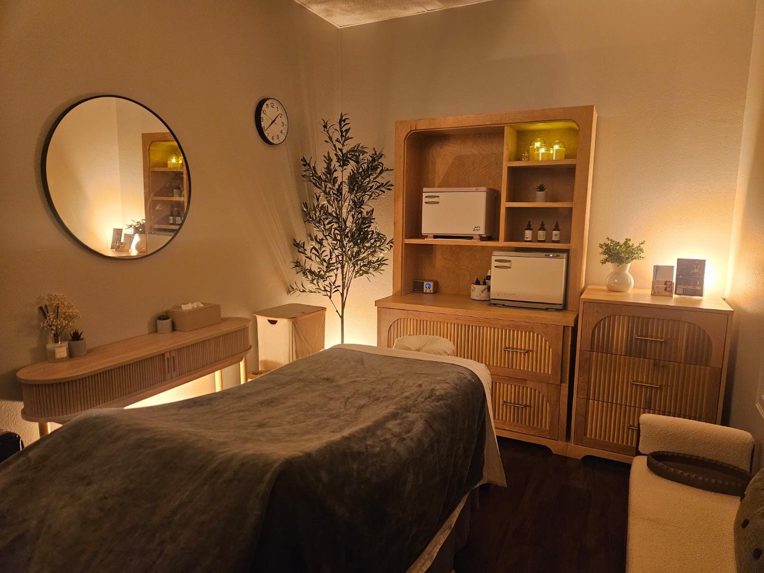 Bia’s treatment room — warm wood, linen, and low light